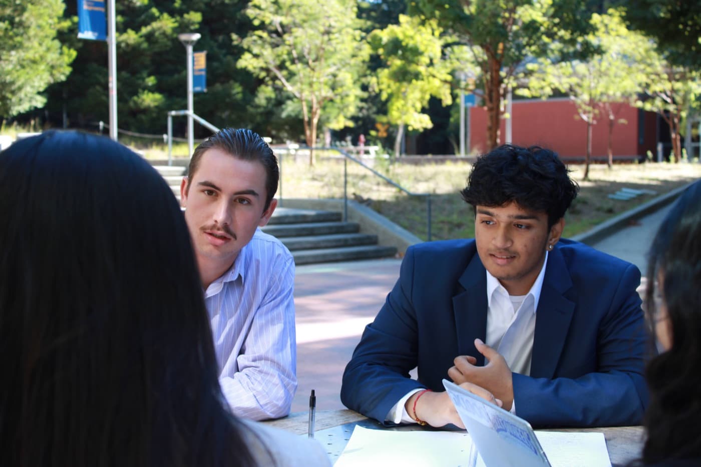 180DC UCSC members working at a table